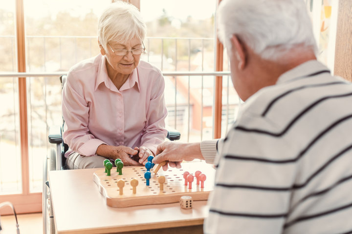 old people playing a board game