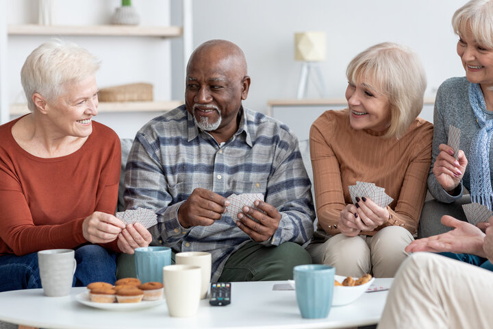 a few people playing cards in a care home