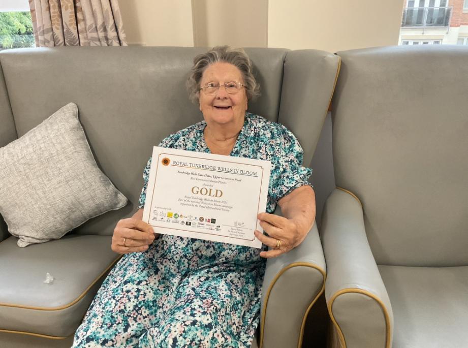 resident with the certificate in her hand