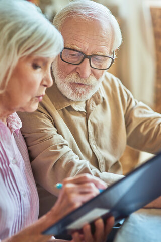 older couple looking at care costing documents together