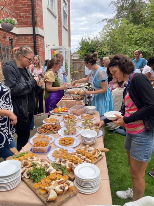 people getting food at bbq