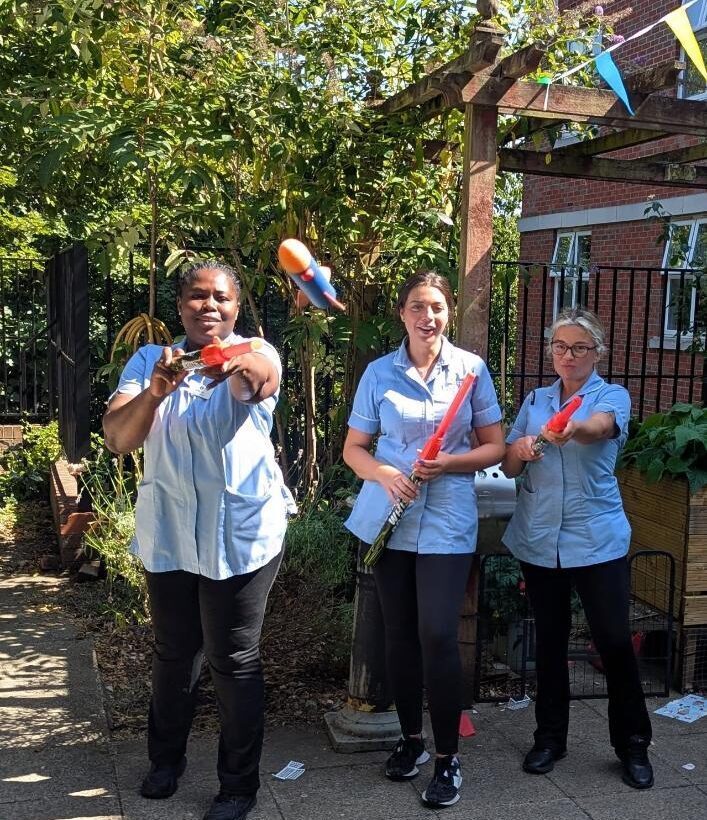staff in uniform with foam rockets